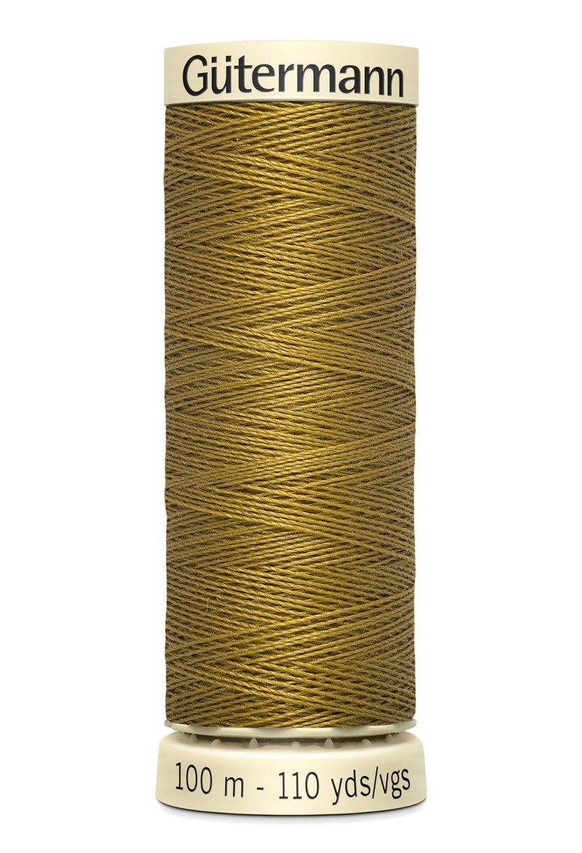 Gutermann Sew-All thread in a golden brown color on a spool.