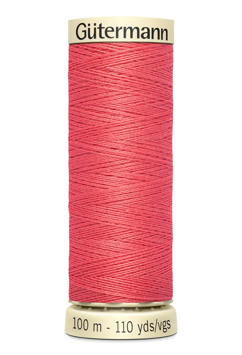 Gütermann Sew-All thread, 100m spool, coral color.