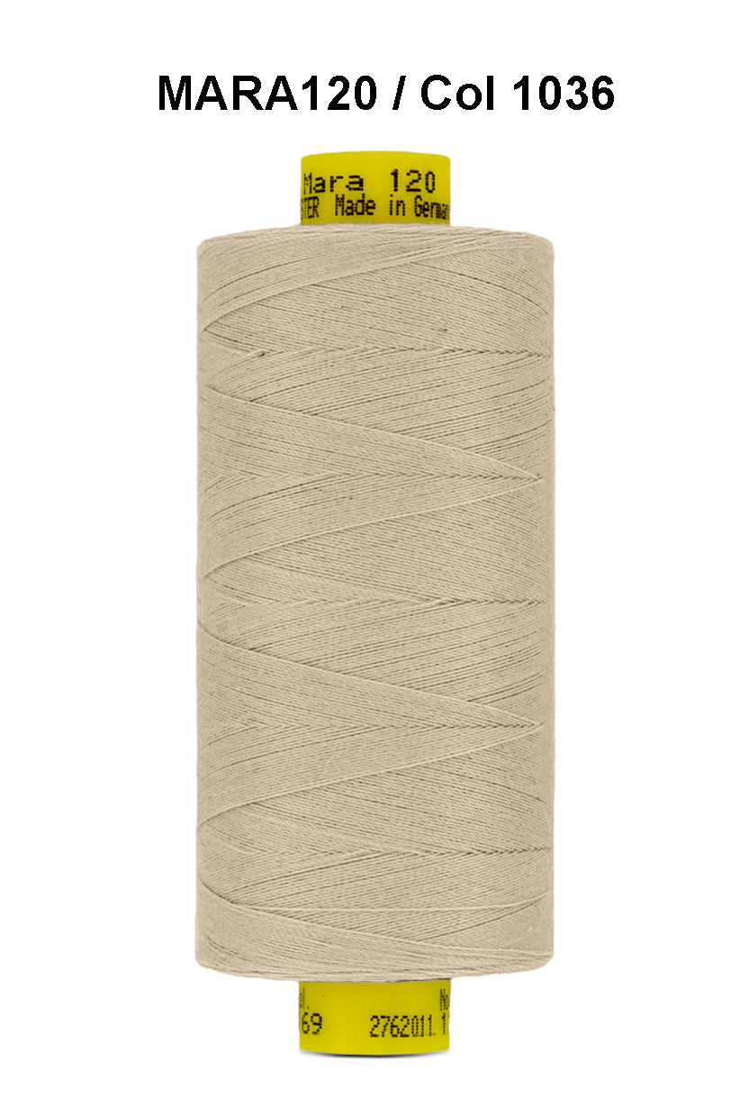 A spool of beige Gutermann Mara 120 thread with product information on the label.