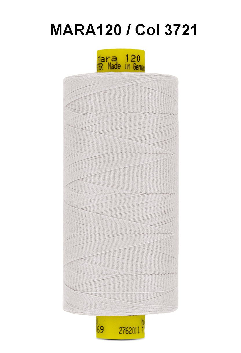 A spool of light grey Gutermann Mara 120 thread with product information printed on the spool.