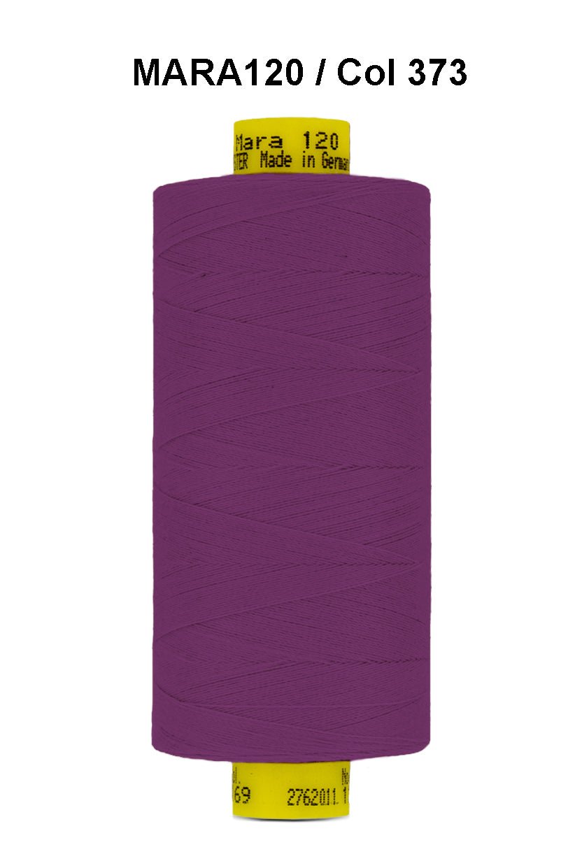 A spool of purple Gutermann Mara 120 thread with a yellow label.