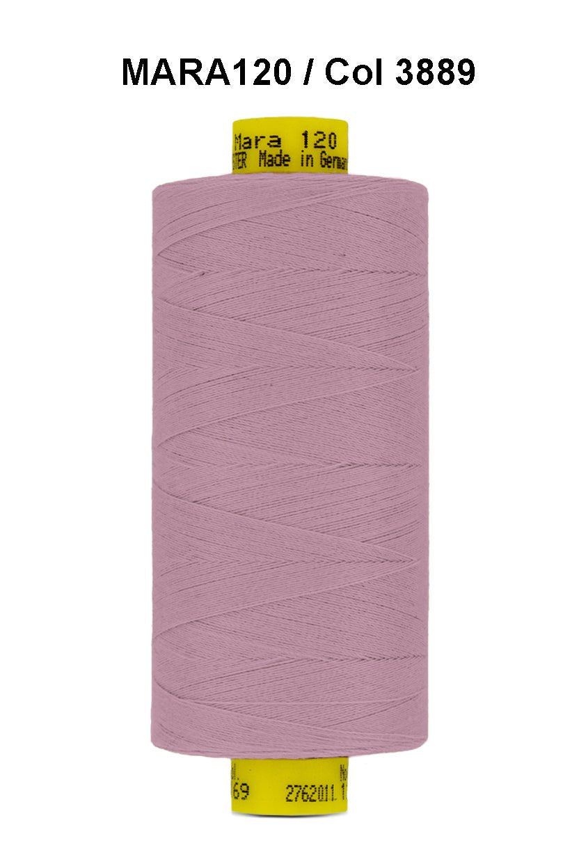 A spool of pink Gutermann Mara 120 thread with yellow labeling.
