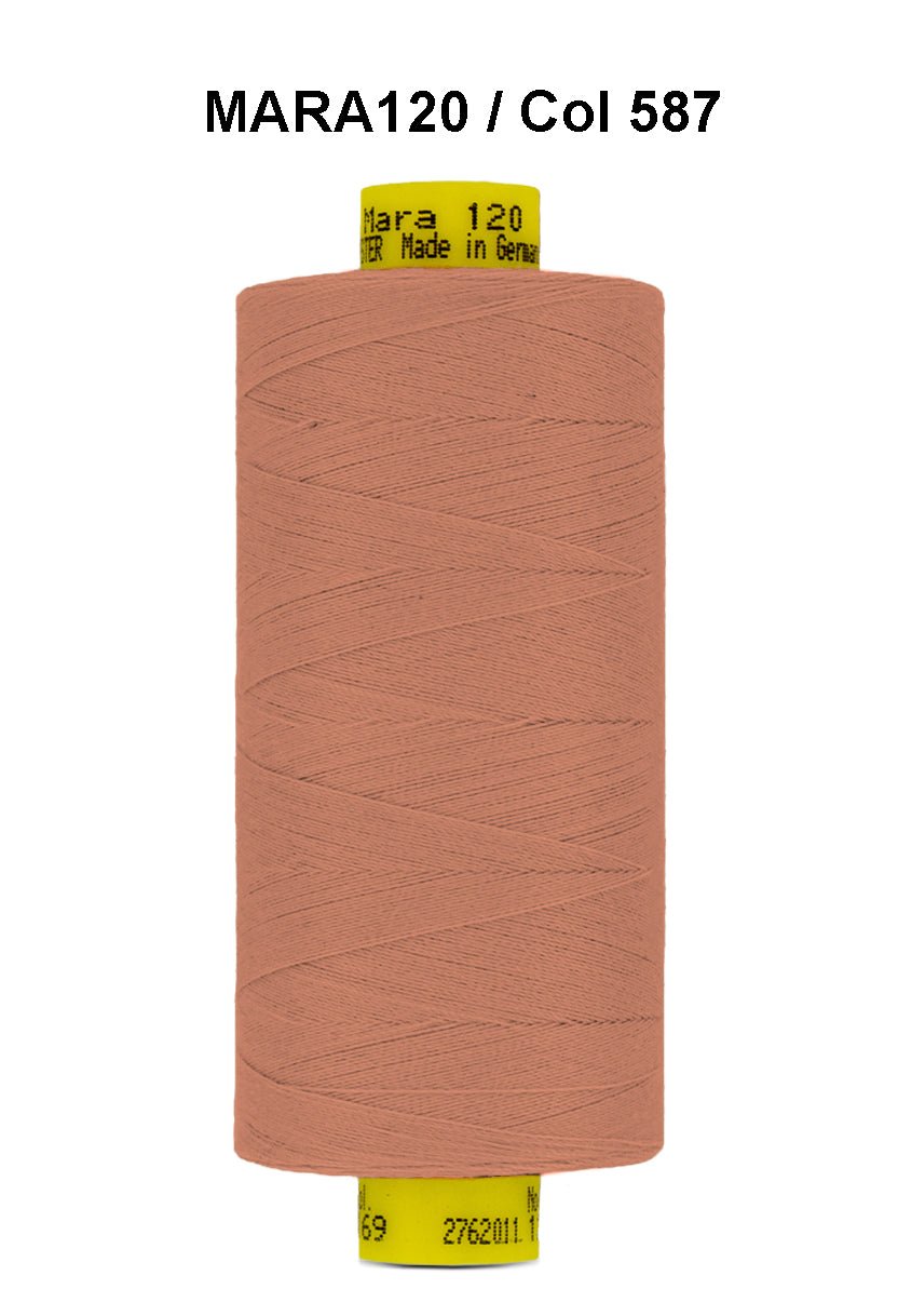 A spool of peach colored Gutermann Mara 120 thread.