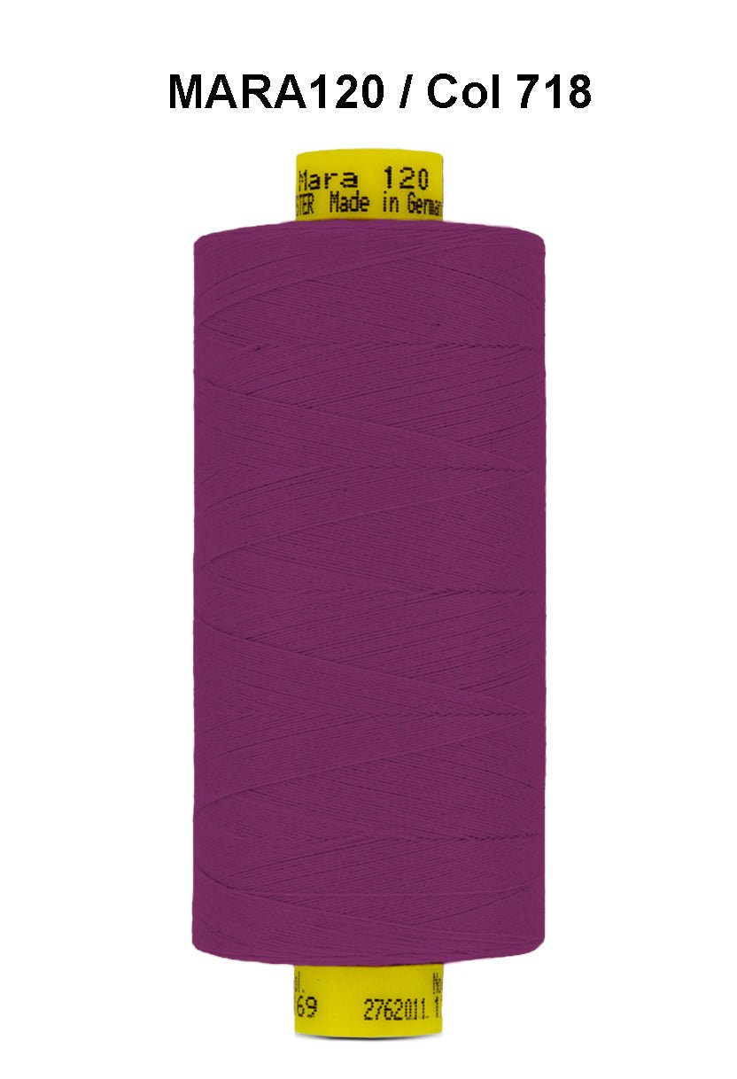 A spool of purple Gutermann Mara 120 thread with a yellow label.