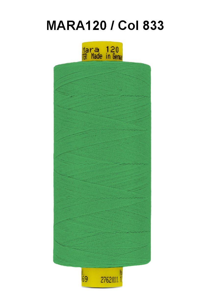 Green Gutermann Mara 120 thread on a spool with product information.