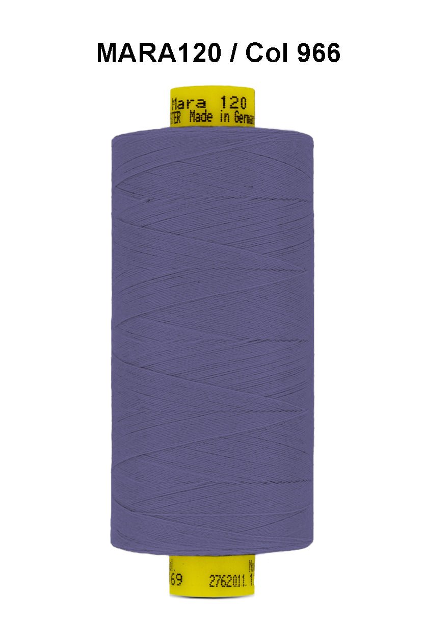 A spool of purple Gutermann Mara 120 thread with yellow labeling.