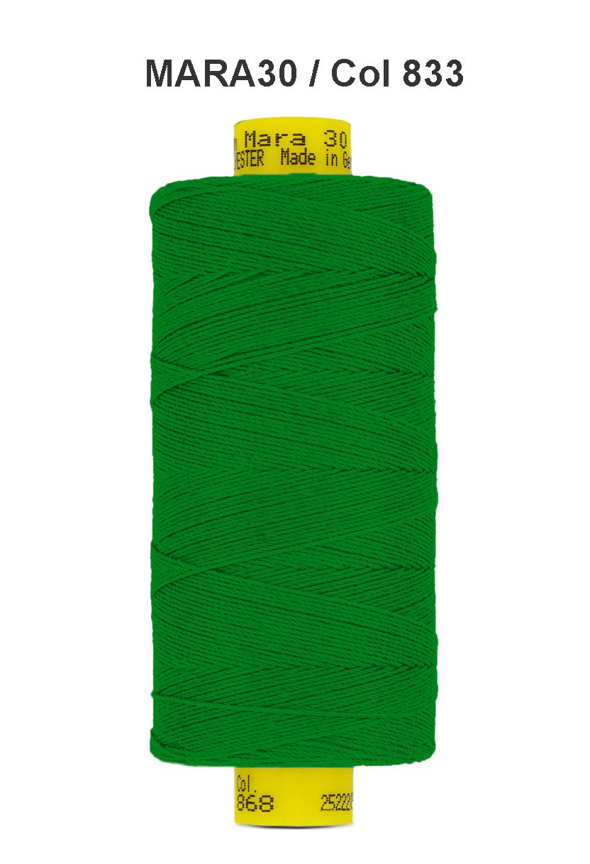 Green Gutermann Mara 30 polyester thread on a spool.