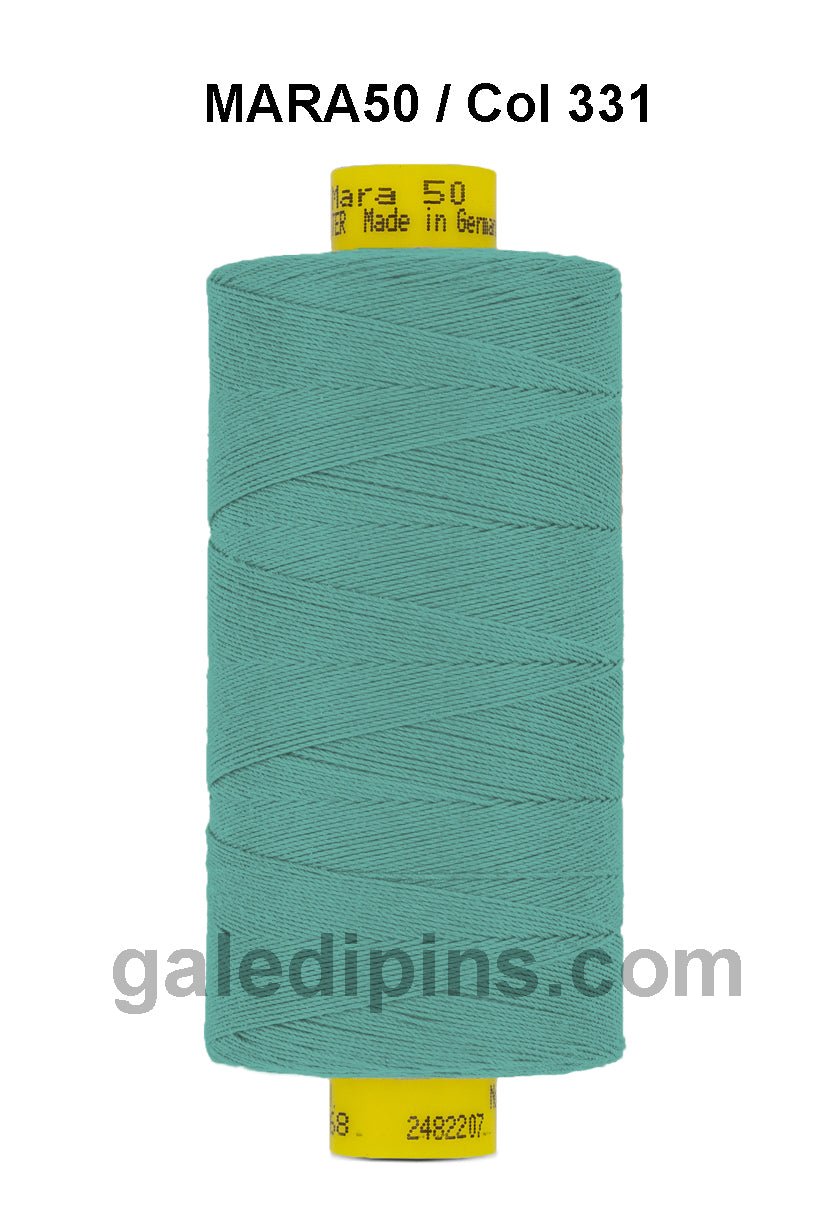 A spool of teal Mara 50 thread with "Mara 50 Made in Germany" printed on the yellow top.