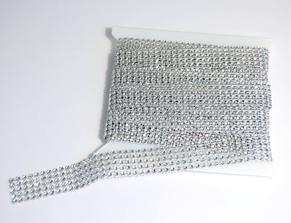 A spool of five-line clear jewel beaded trim with faceted gems on a white background.