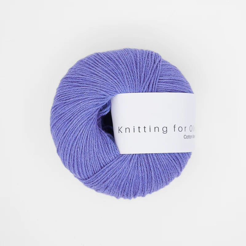 A ball of Knitting for Olive Cotton Merino yarn in Lavender Blue with a white paper label.