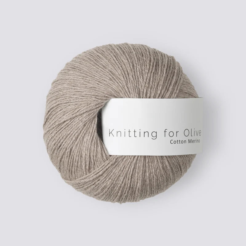 A ball of Knitting for Olive Cotton Merino yarn in a light oatmeal beige color.