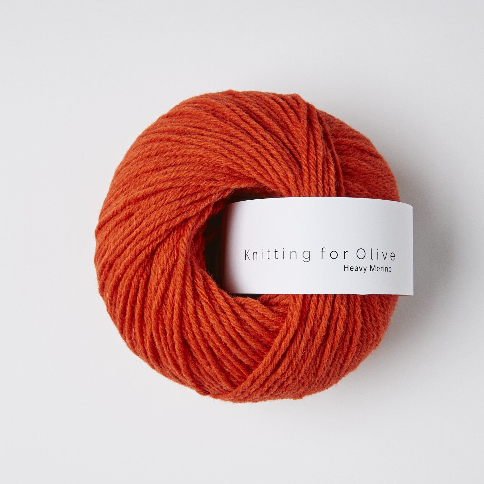 A ball of rust-colored Heavy Merino yarn from Knitting For Olive.