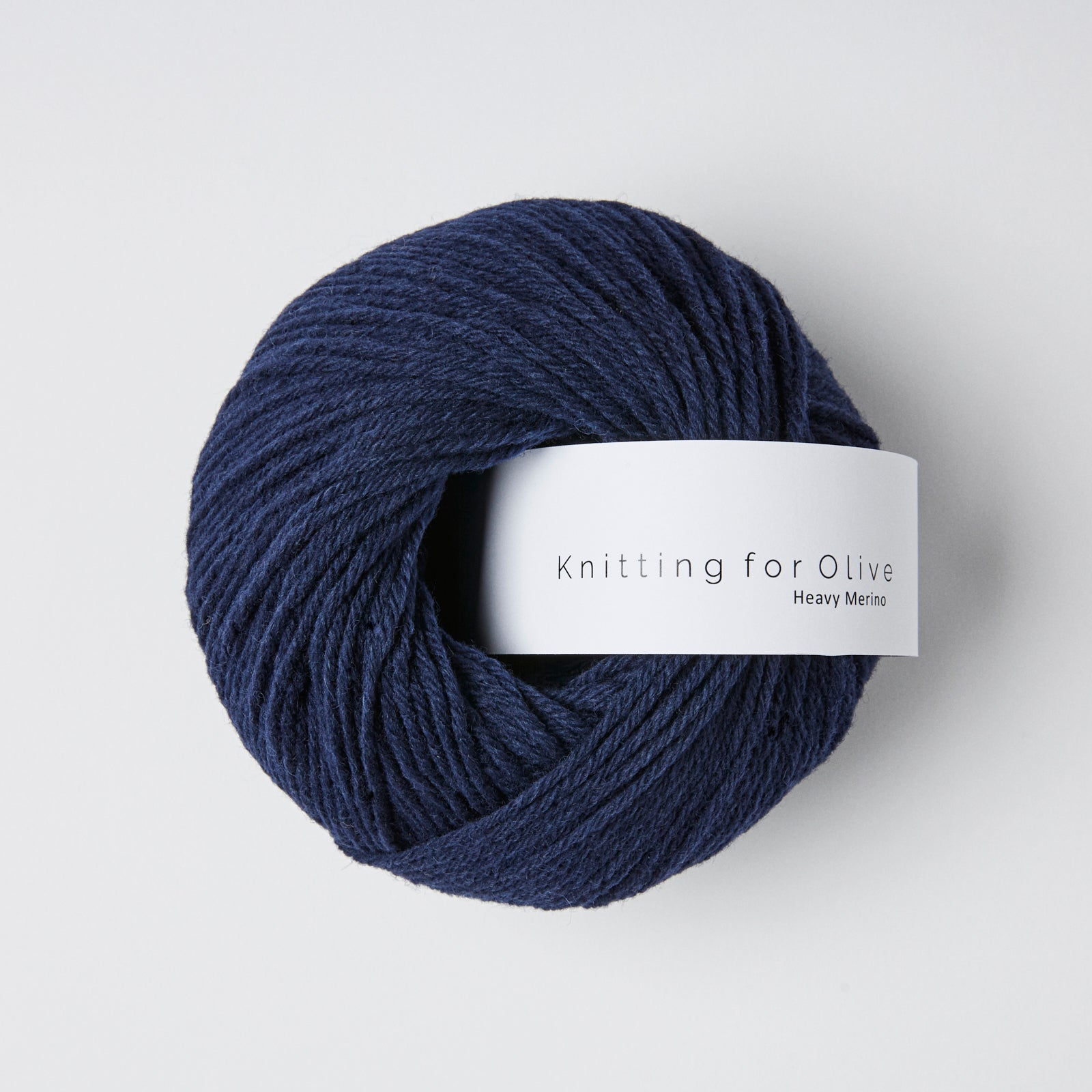 A ball of dark blue Heavy Merino yarn from Knitting For Olive.