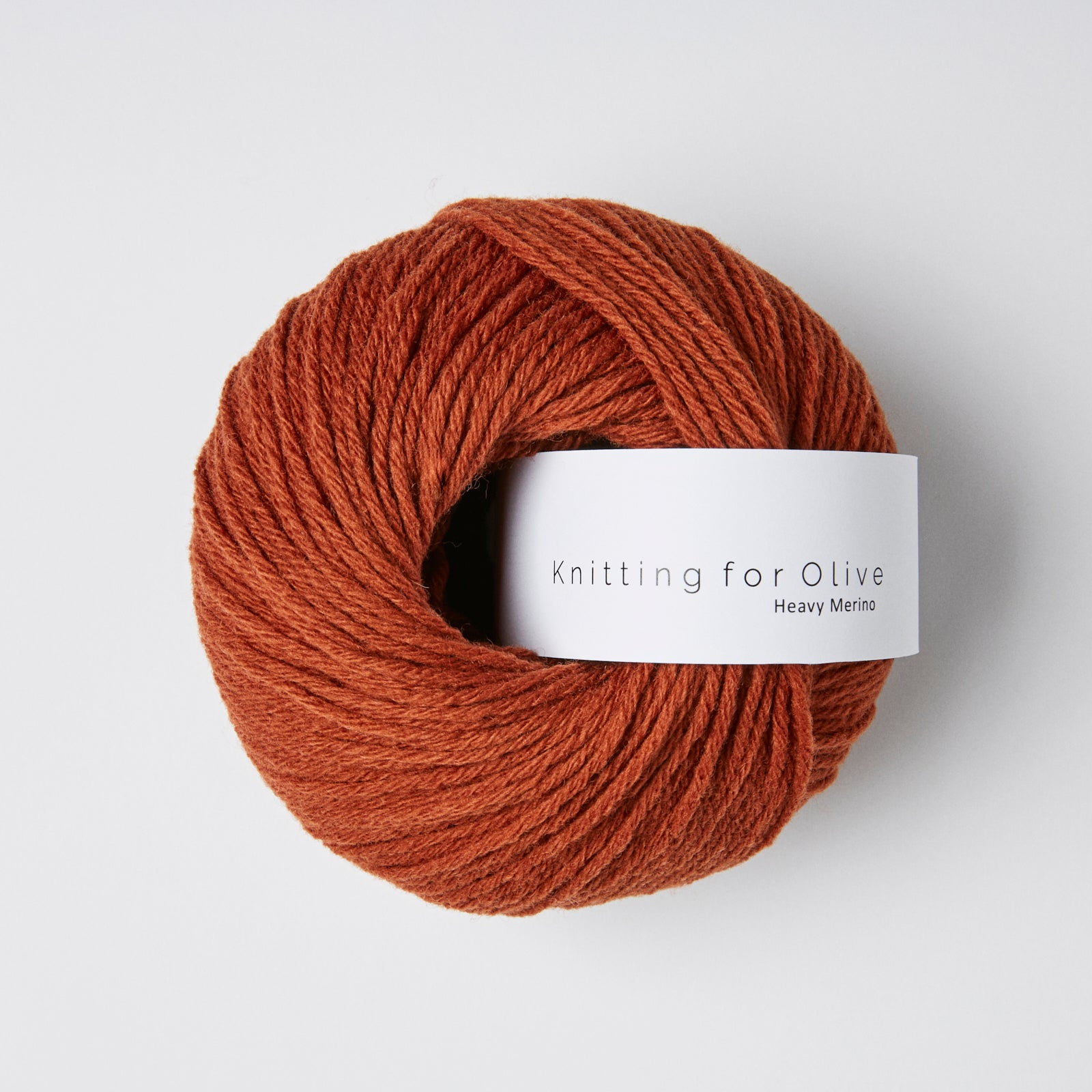 A ball of rust-colored Heavy Merino yarn from Knitting for Olive.