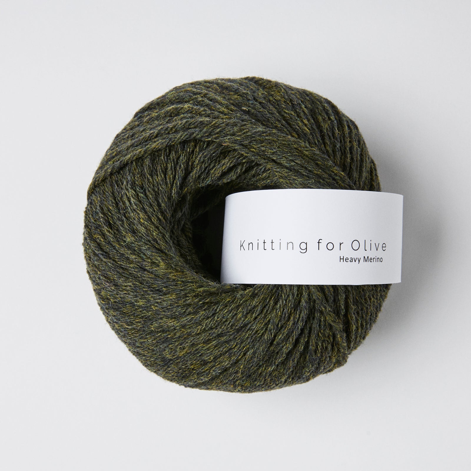 A ball of dark green and yellow speckled Heavy Merino yarn from Knitting for Olive.