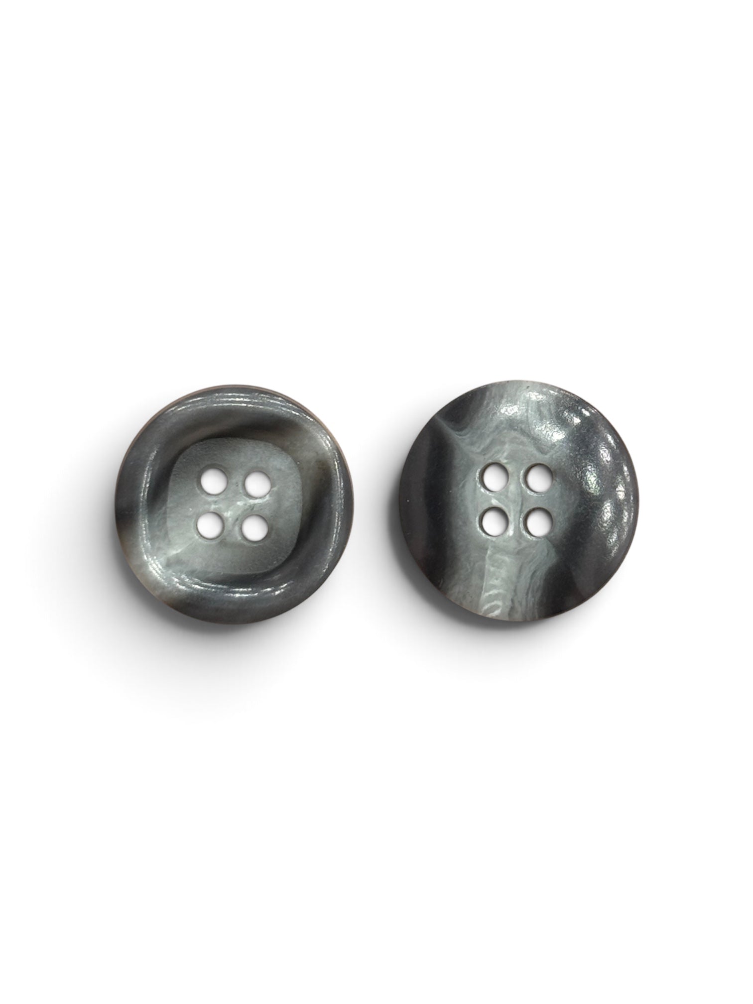 Two 18mm grey and tinted white marbled resin 4-hole round sewing buttons on a white background.
