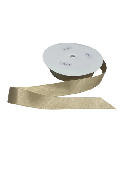 A spool of double-faced satin ribbon in a champagne color.