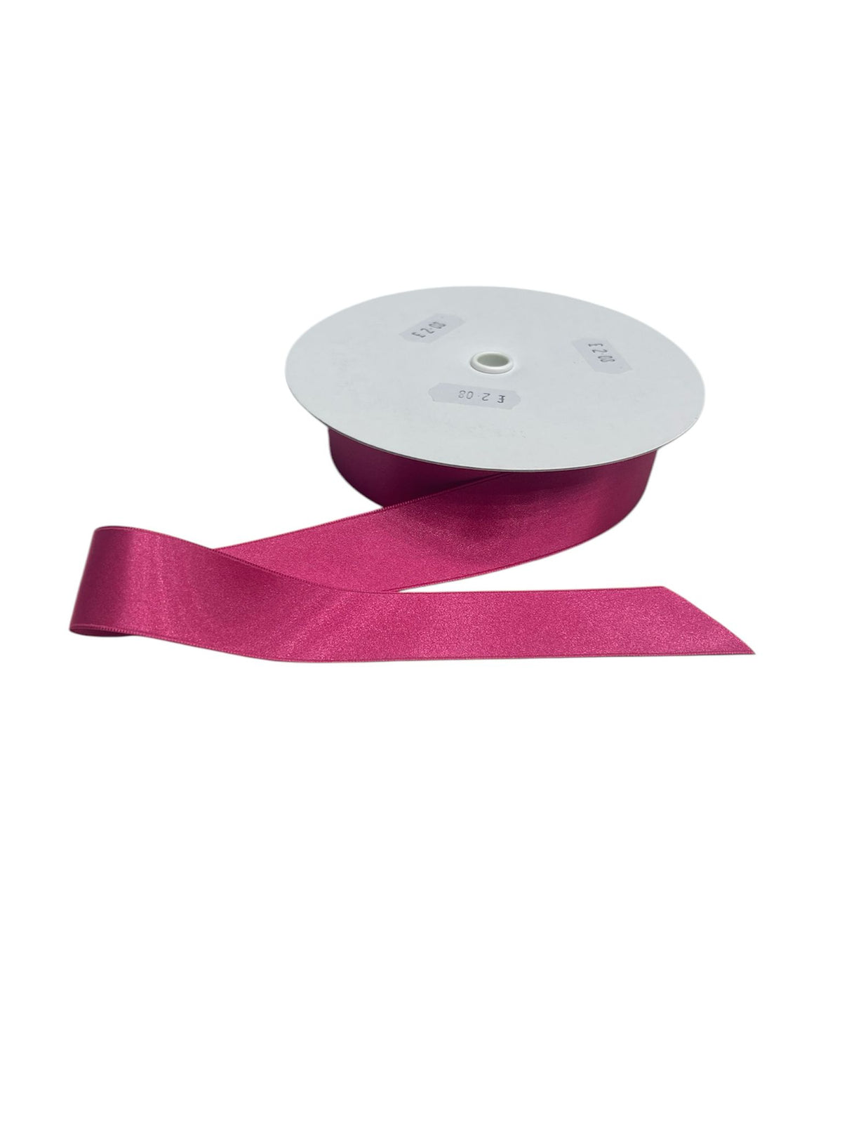 A roll of fuchsia double-faced satin ribbon with a cut end.