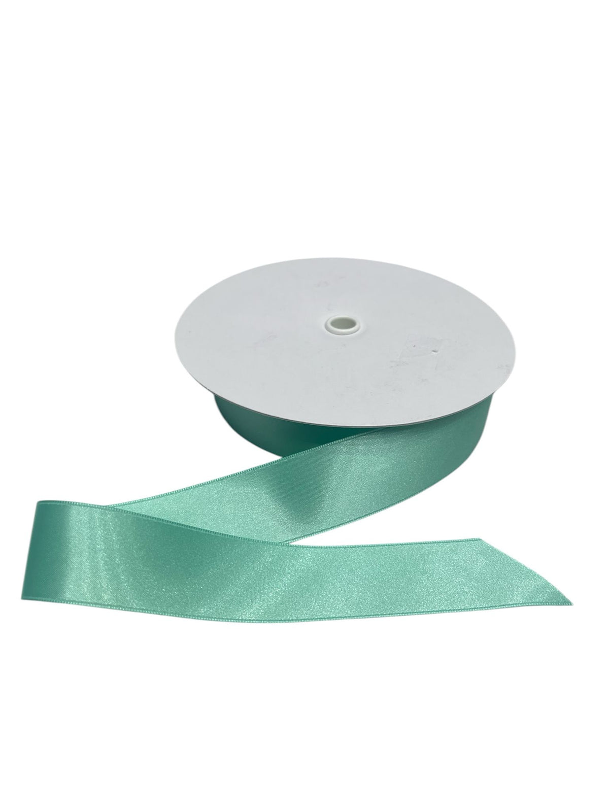A spool of teal double-faced satin ribbon with the ribbon unspooled.