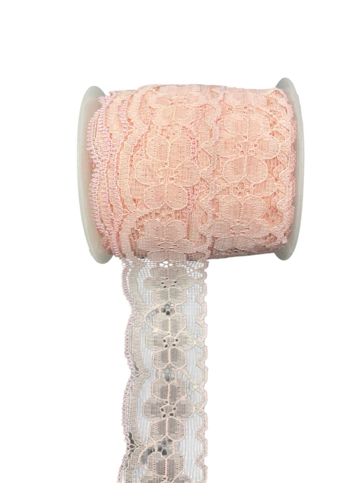 A roll of light pink embroidered lace trim with a scalloped edge.
