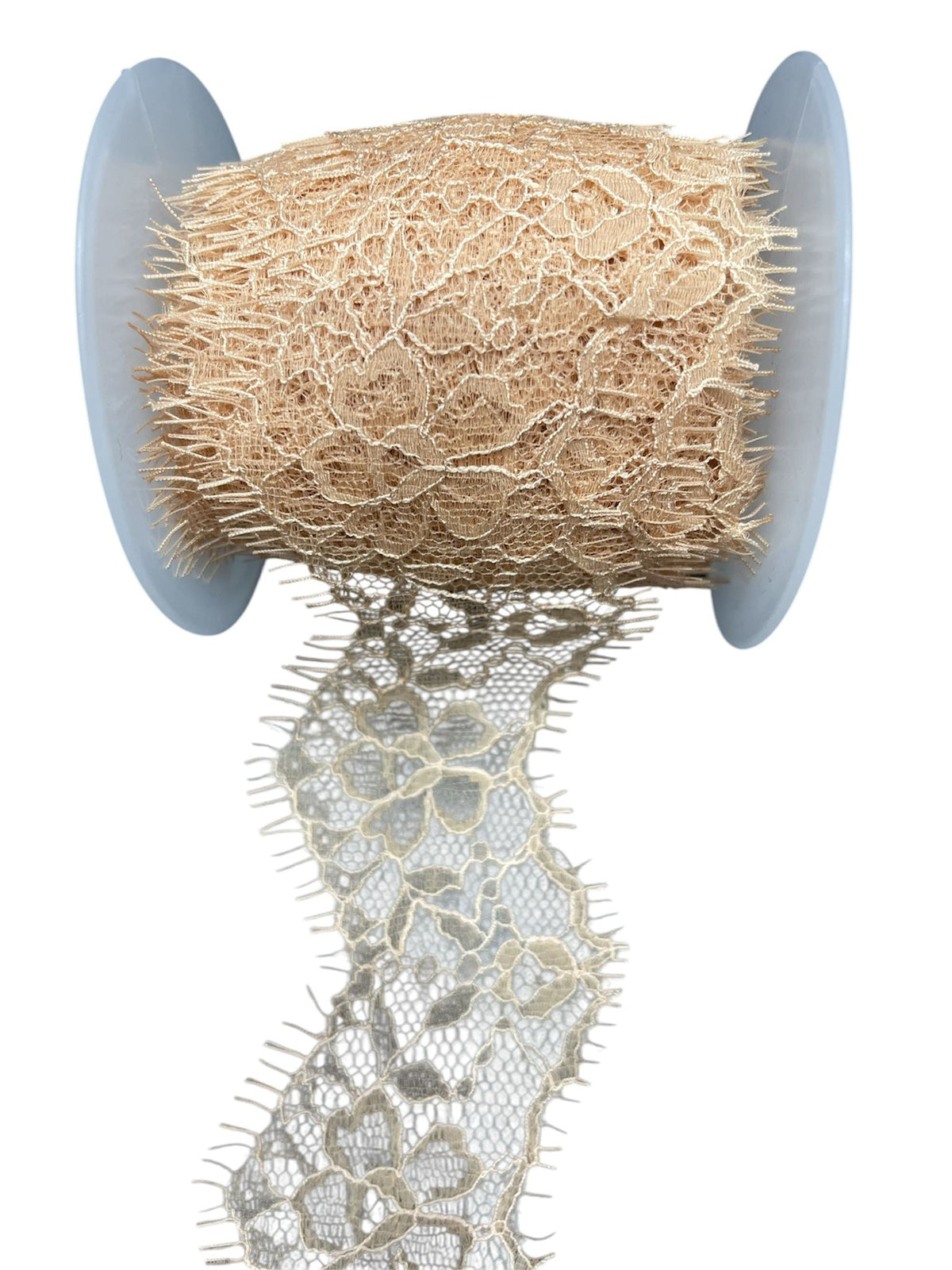 Lace tape with embroidered tulle trim on a spool.
