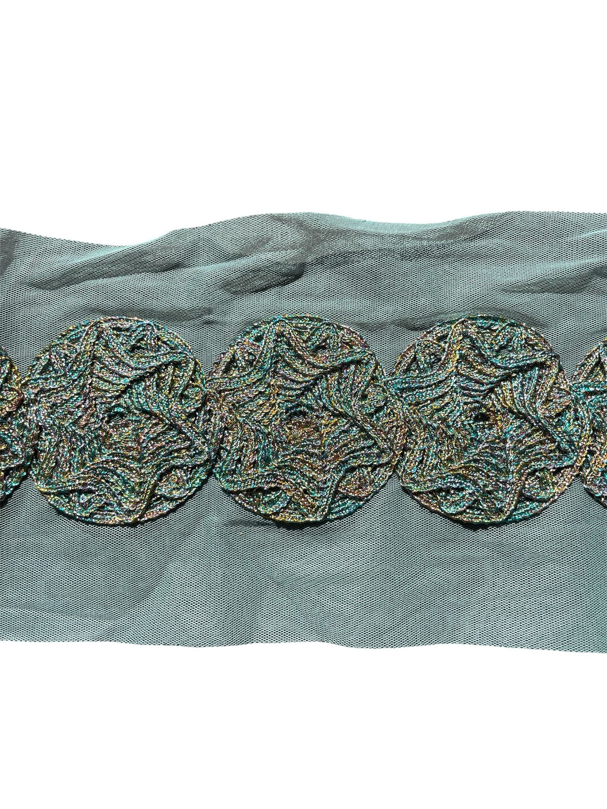 Fancy embroidered tulle trim with circular patterns.