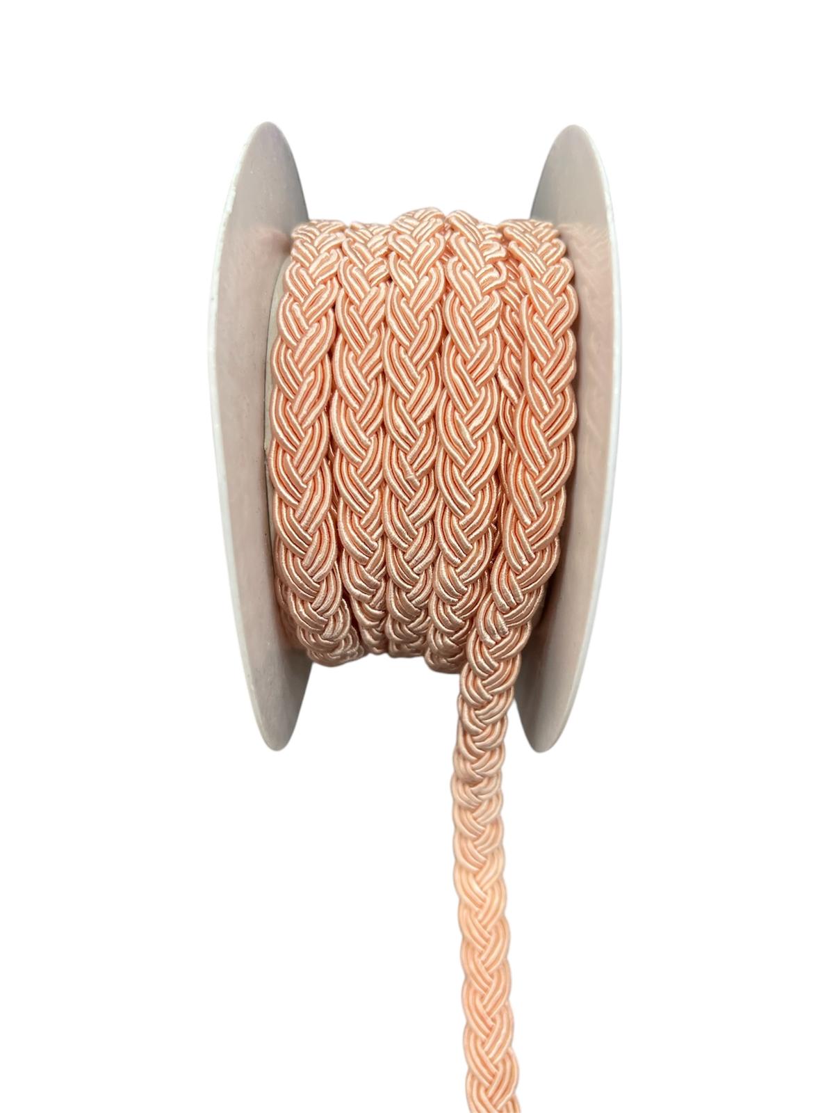 Rolled peach braided cord trim on a white spool.