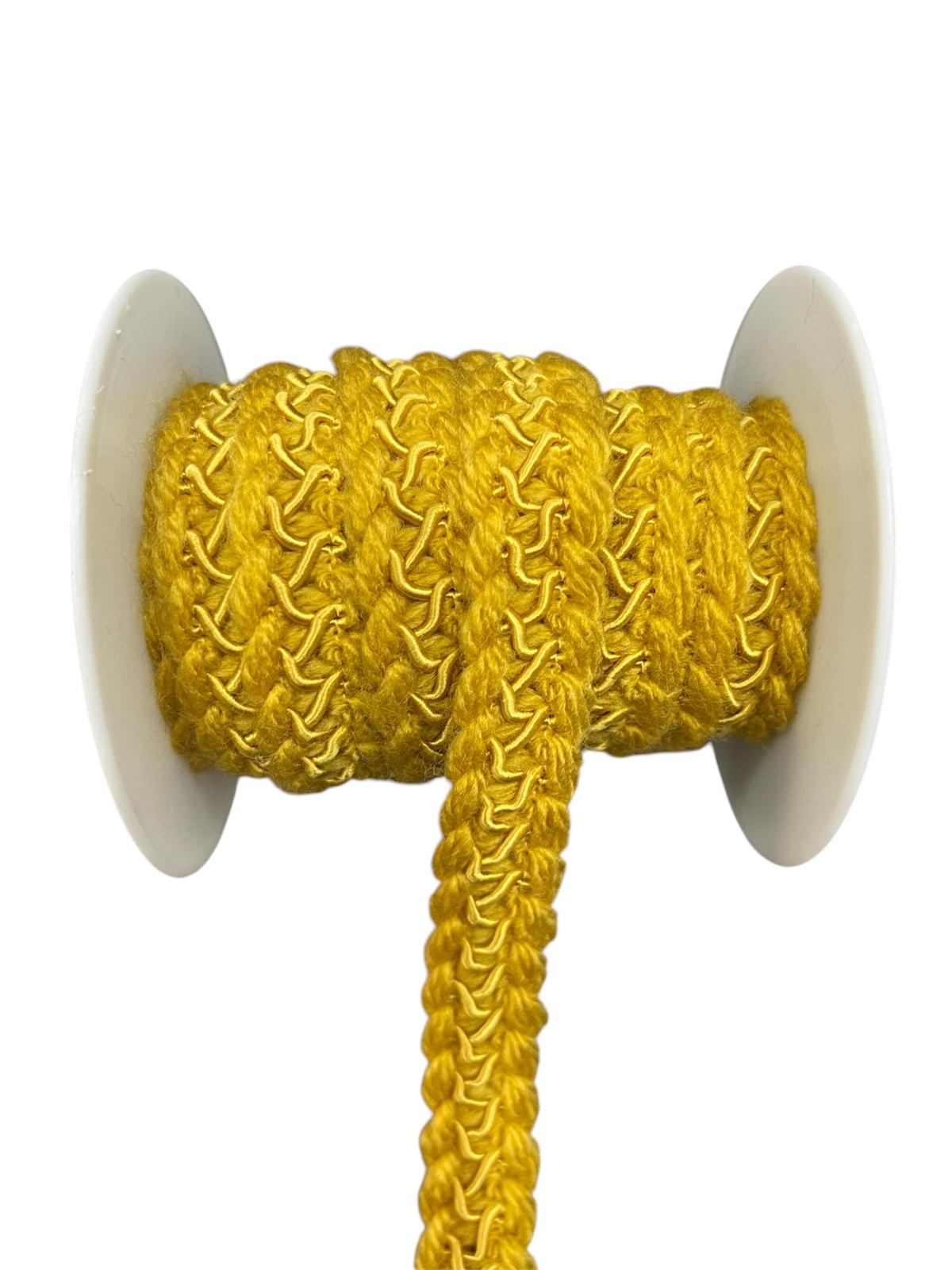 Yellow decorative lace trim cord on a spool.