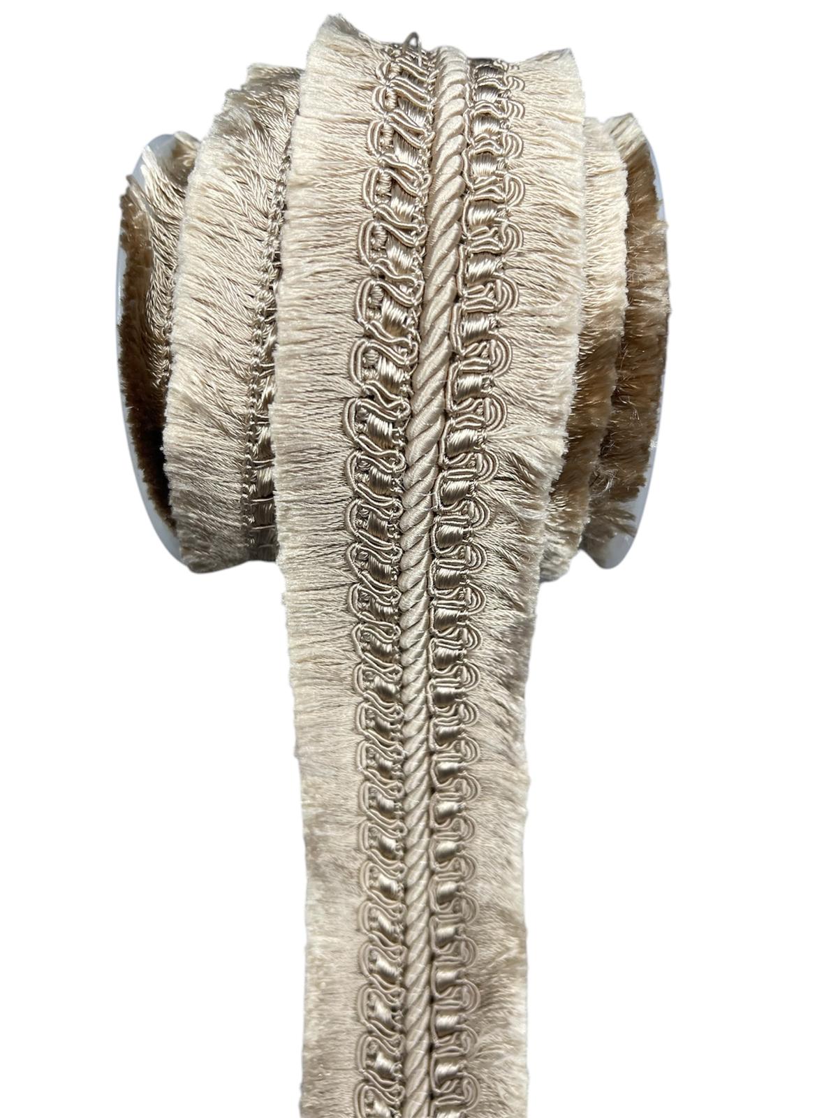 Beige decorative lace trim cord with fringe and braided details.