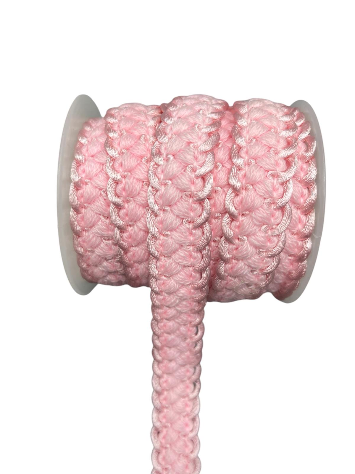 Rolled pink decorative trim cord with a braided texture.
