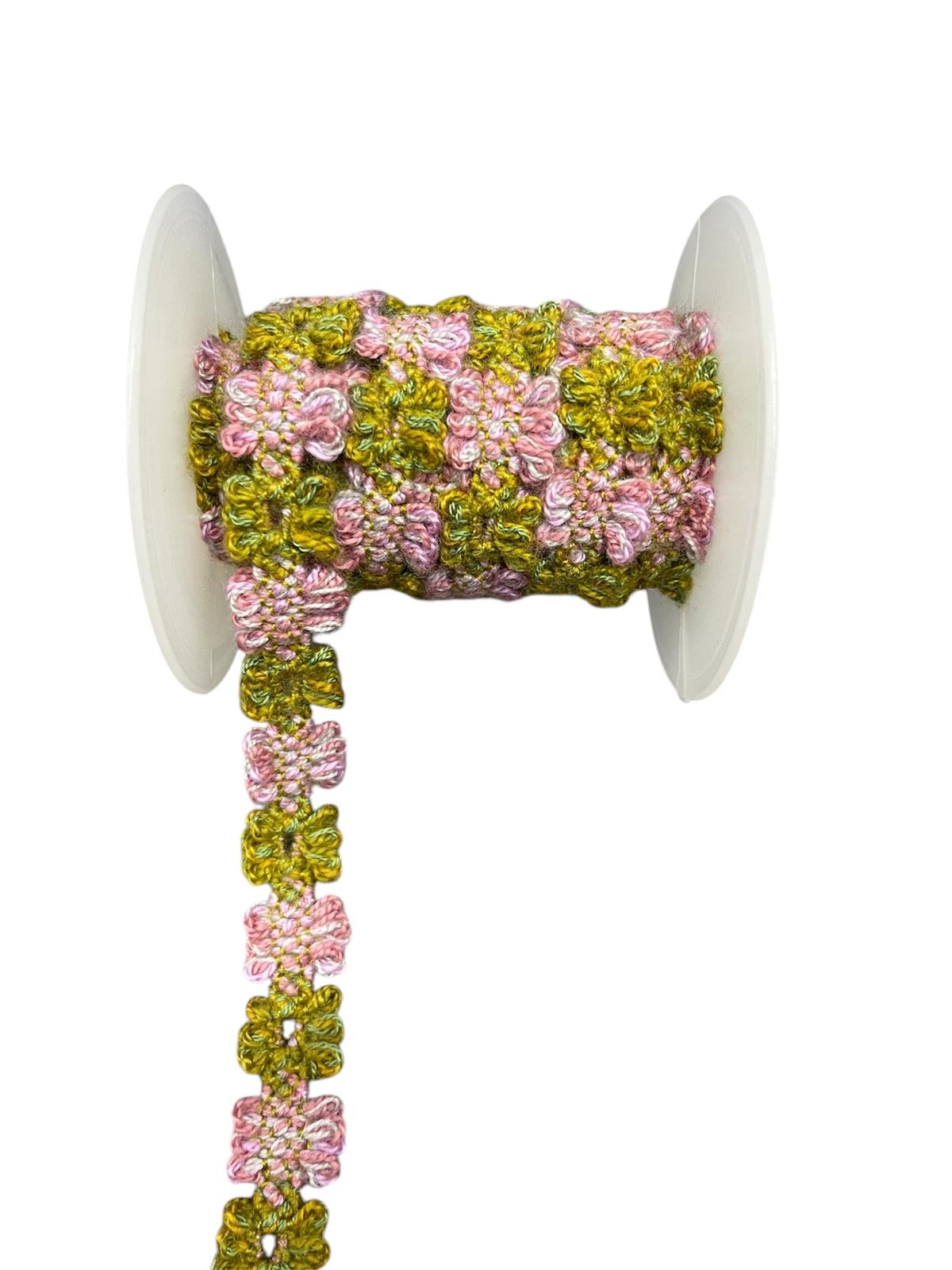 Decorative trim cord with pink and green floral pattern on a white spool.
