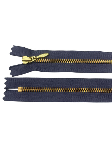 YKK size 3 closed end gold metal zipper on navy fabric.
