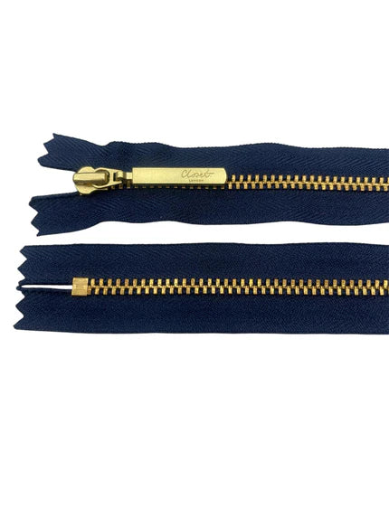 YKK size 3 closed end gold metal zip on navy fabric.