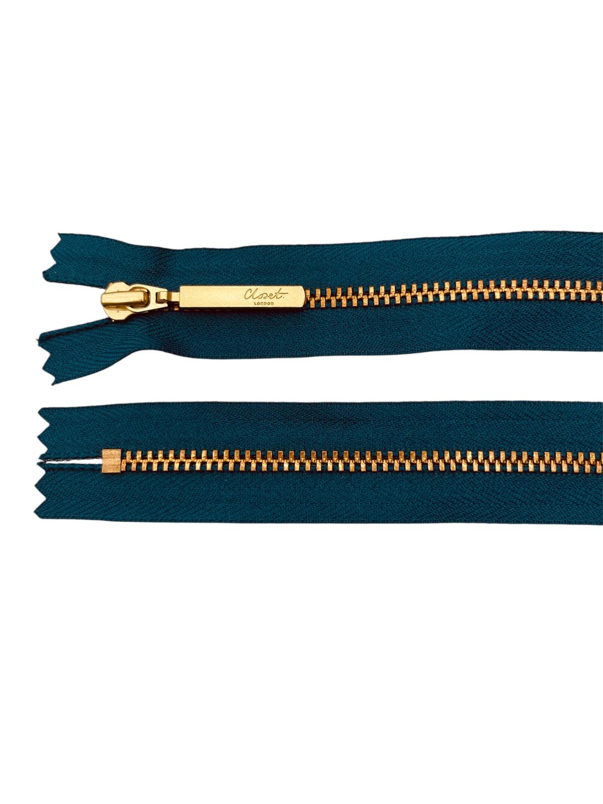 YKK size 3 closed end gold metal zip with teal fabric.