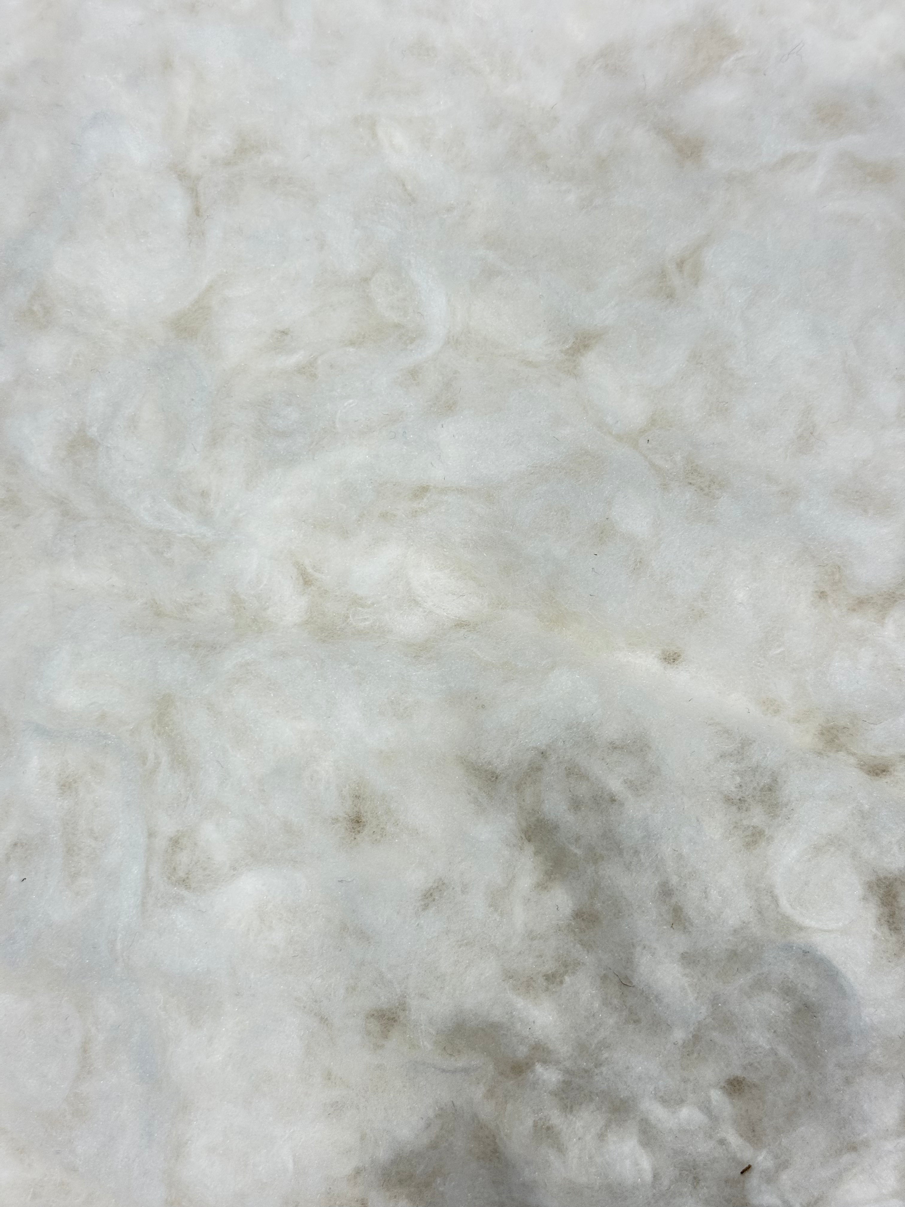 Pure wool wadding fabric by the meter with a soft, fluffy texture.
