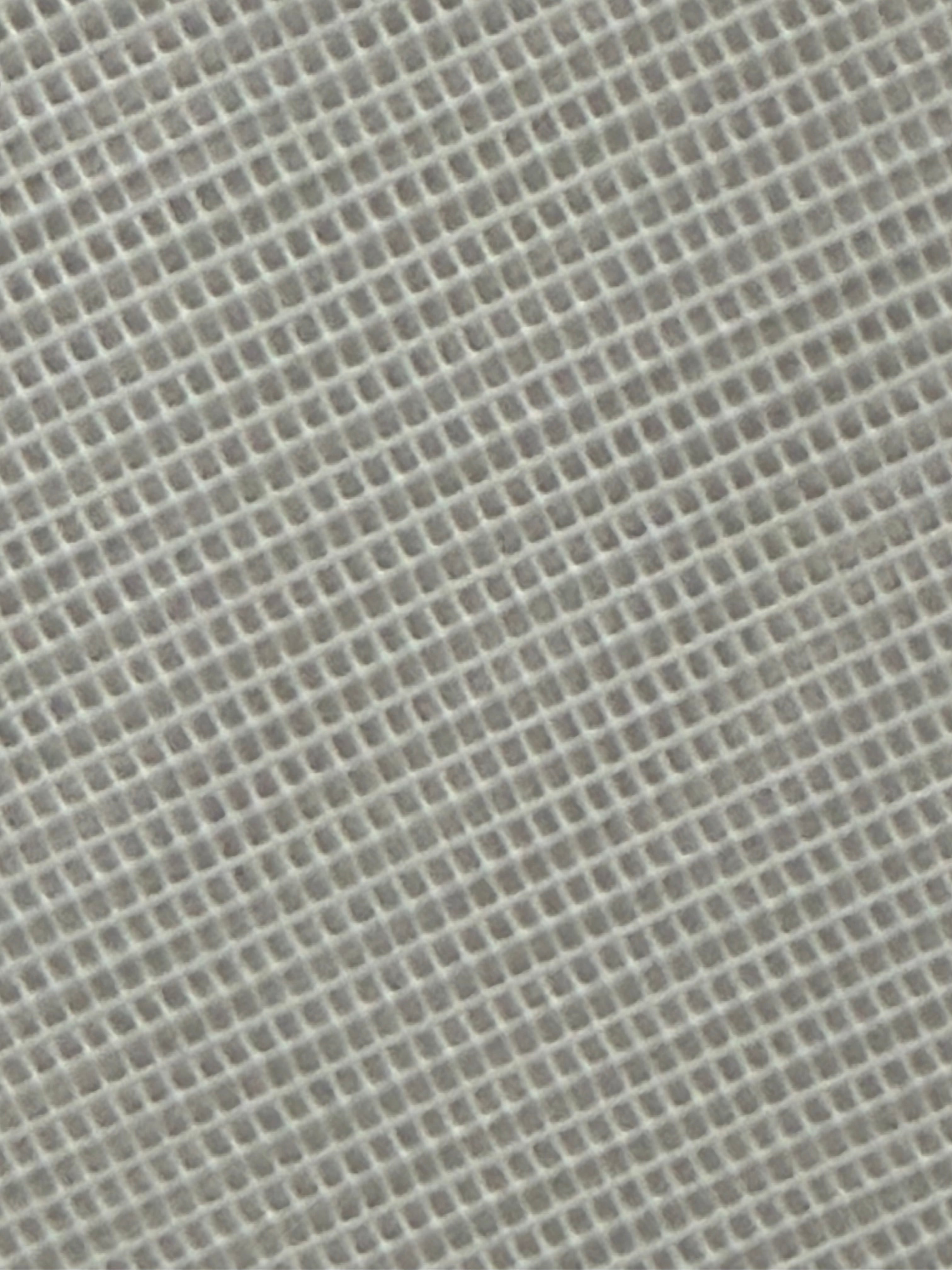 Aida cross stitch fabric with a stiff, square-patterned weave.