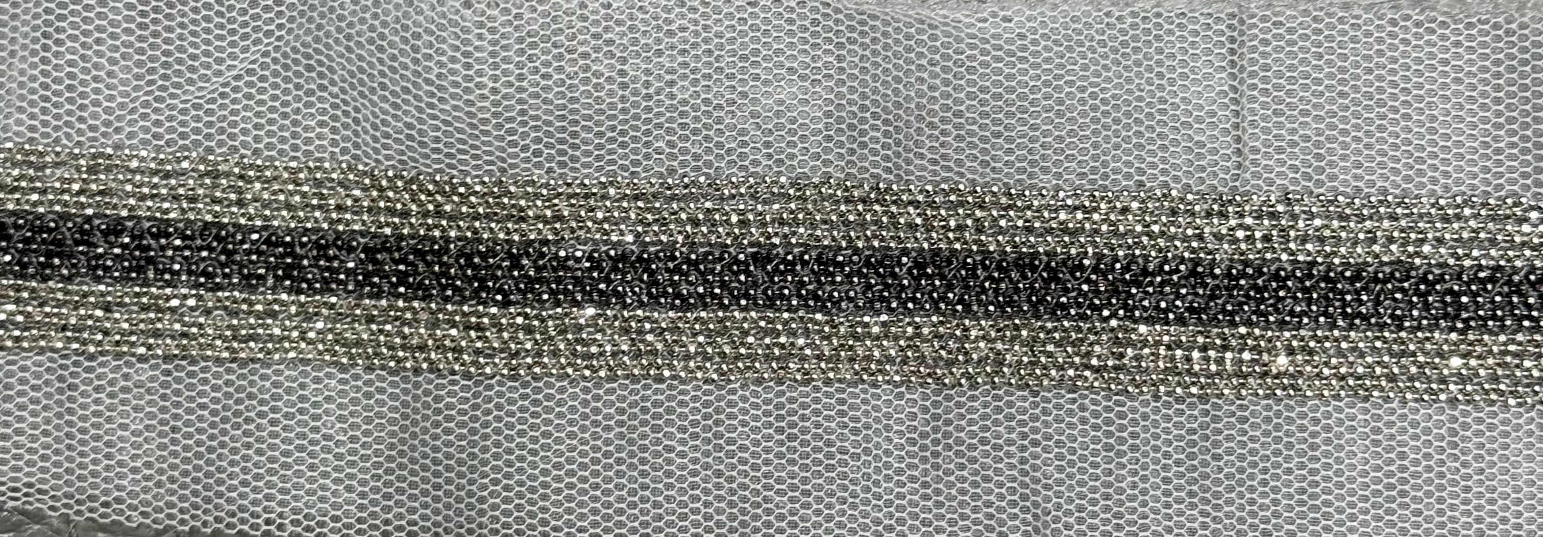 White netted trim with silver and grey bead design.