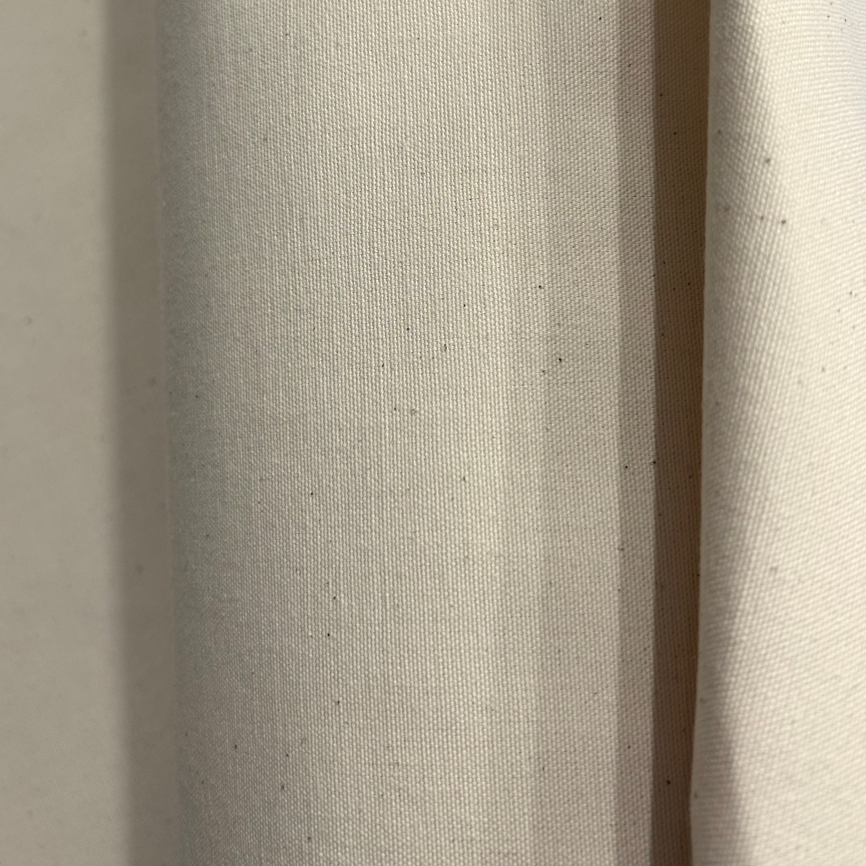 Natural colored heavy cotton calico fabric with a visible weave.