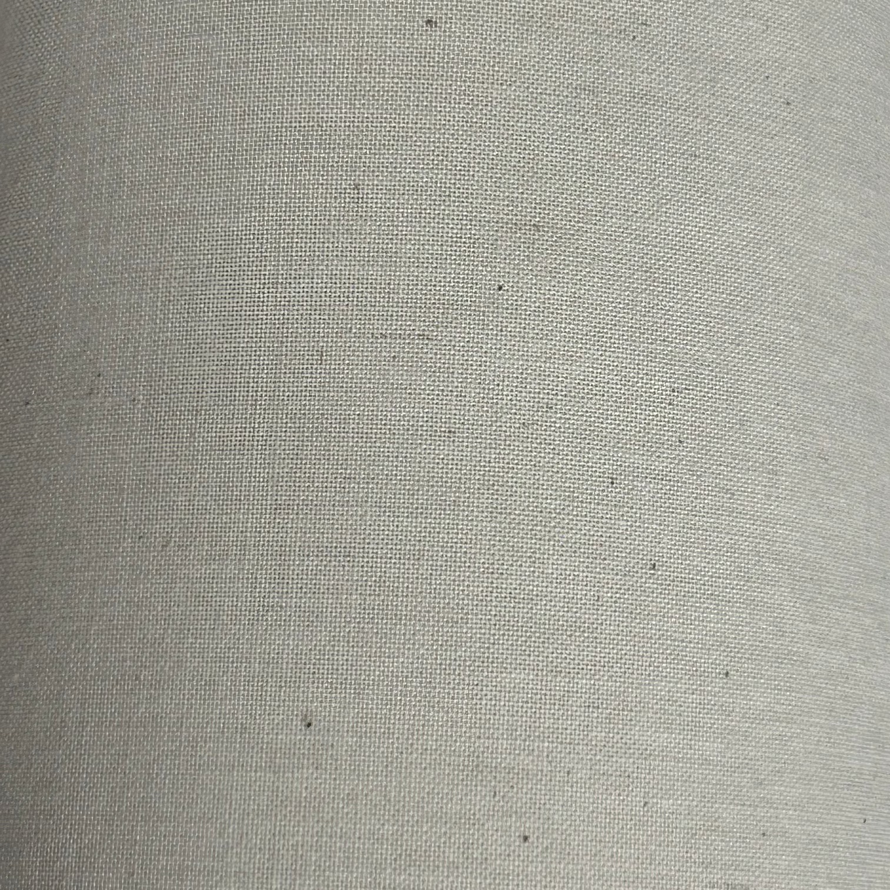 Calico fabric in natural loomstate cotton with a visible weave.