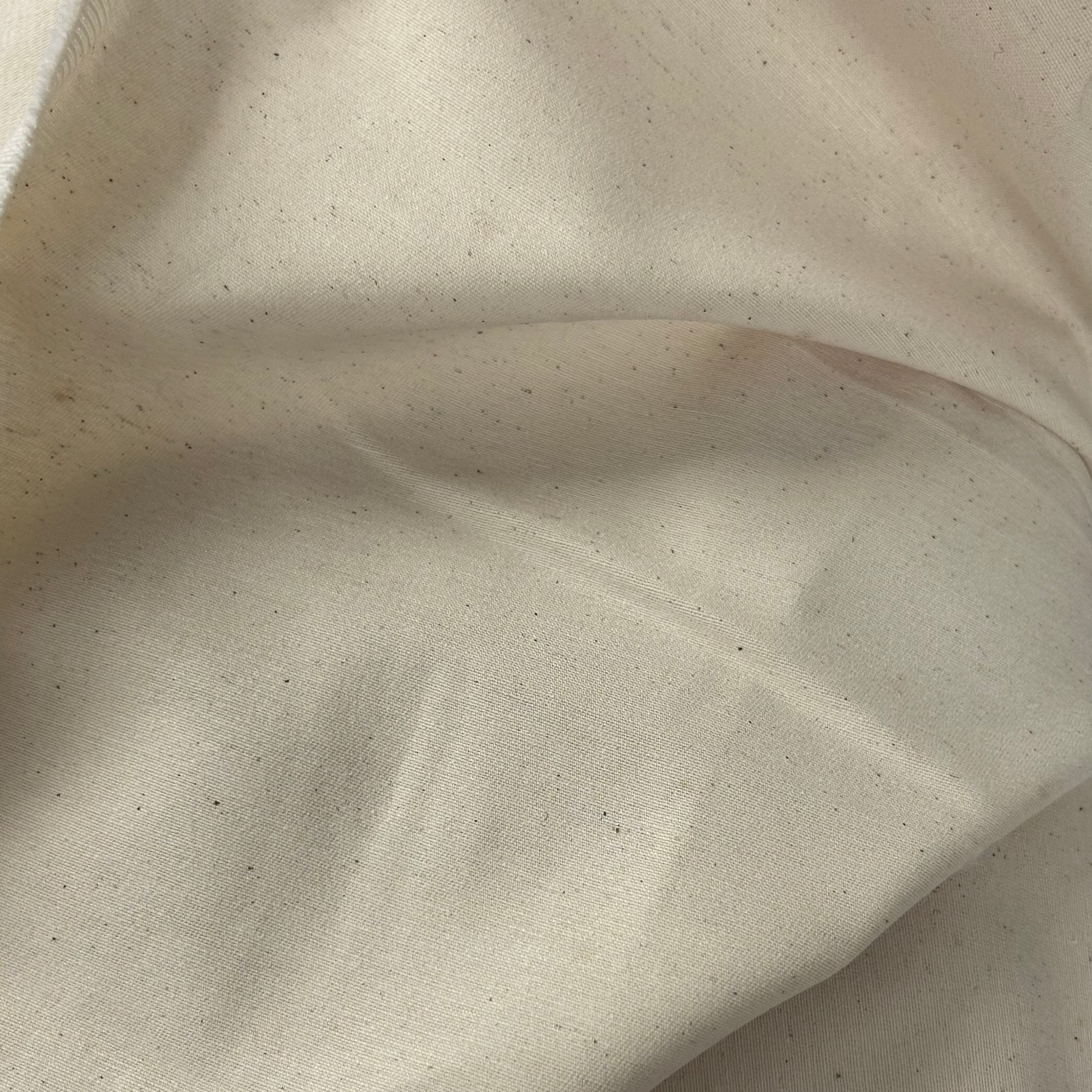 Natural color heavy cotton calico fabric roll with Galedi Pins pattern.