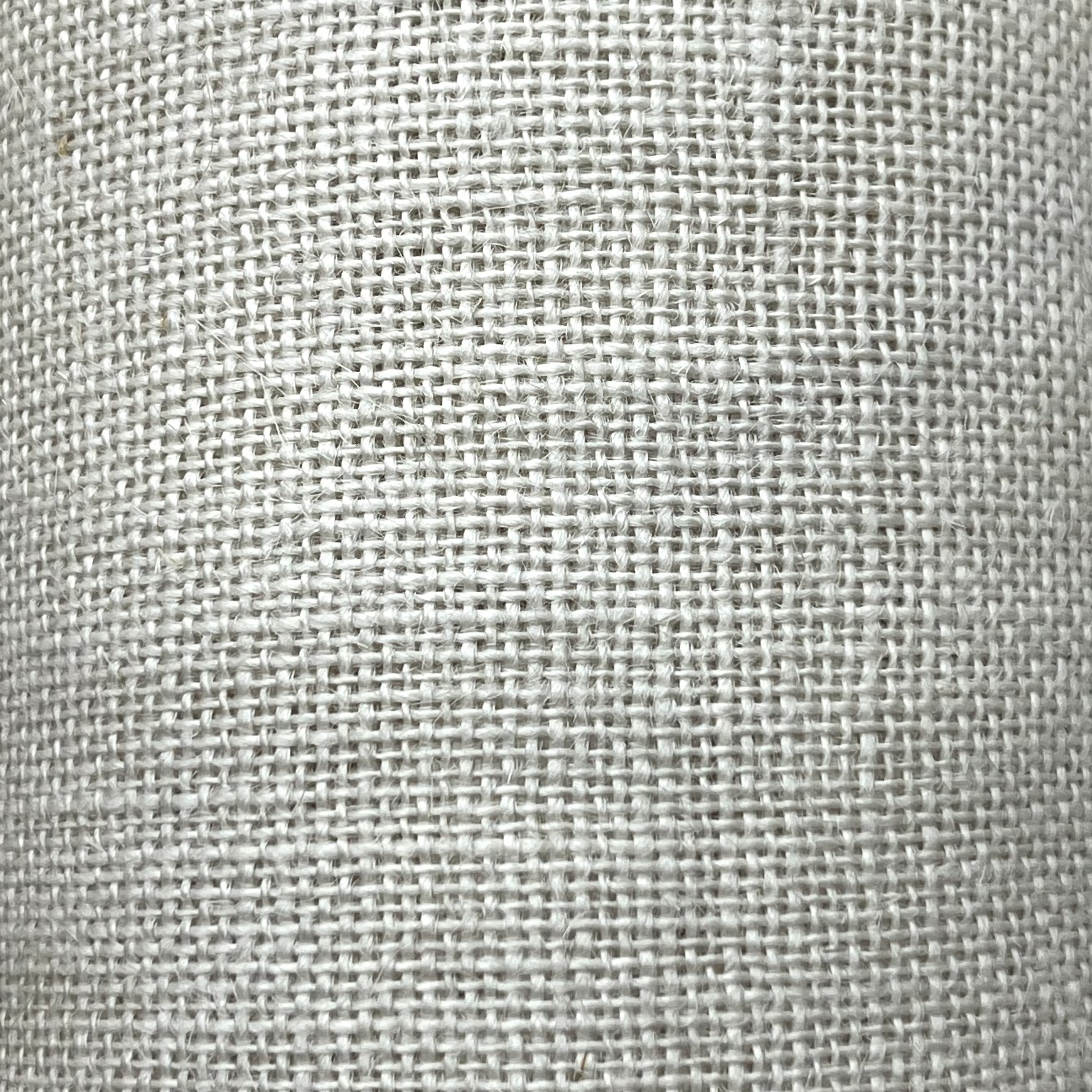A close-up of stone-colored 16-count Aida needlecraft fabric.