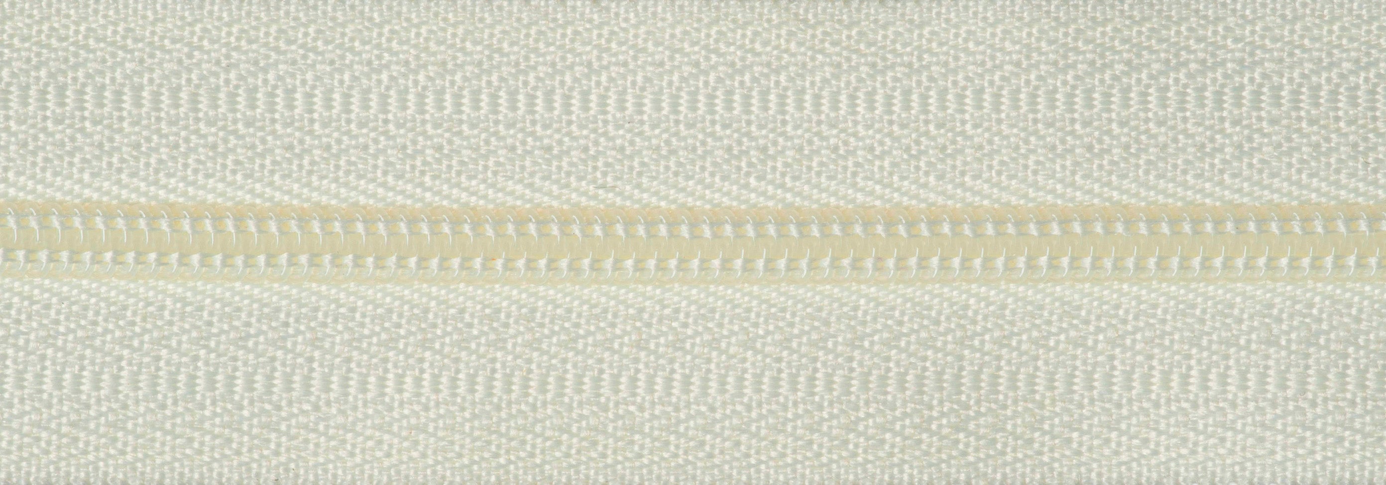 Close-up of a white lightweight nylon coil zipper with polyester tape.