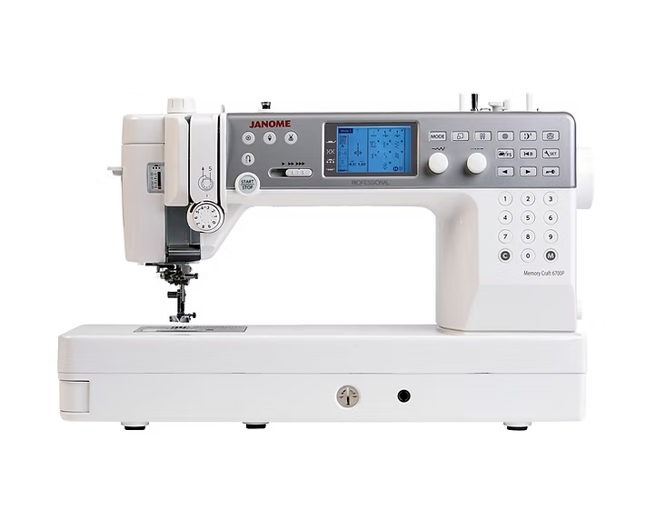 A white Janome Memory Craft 6700P professional sewing machine with a digital display and keypad.