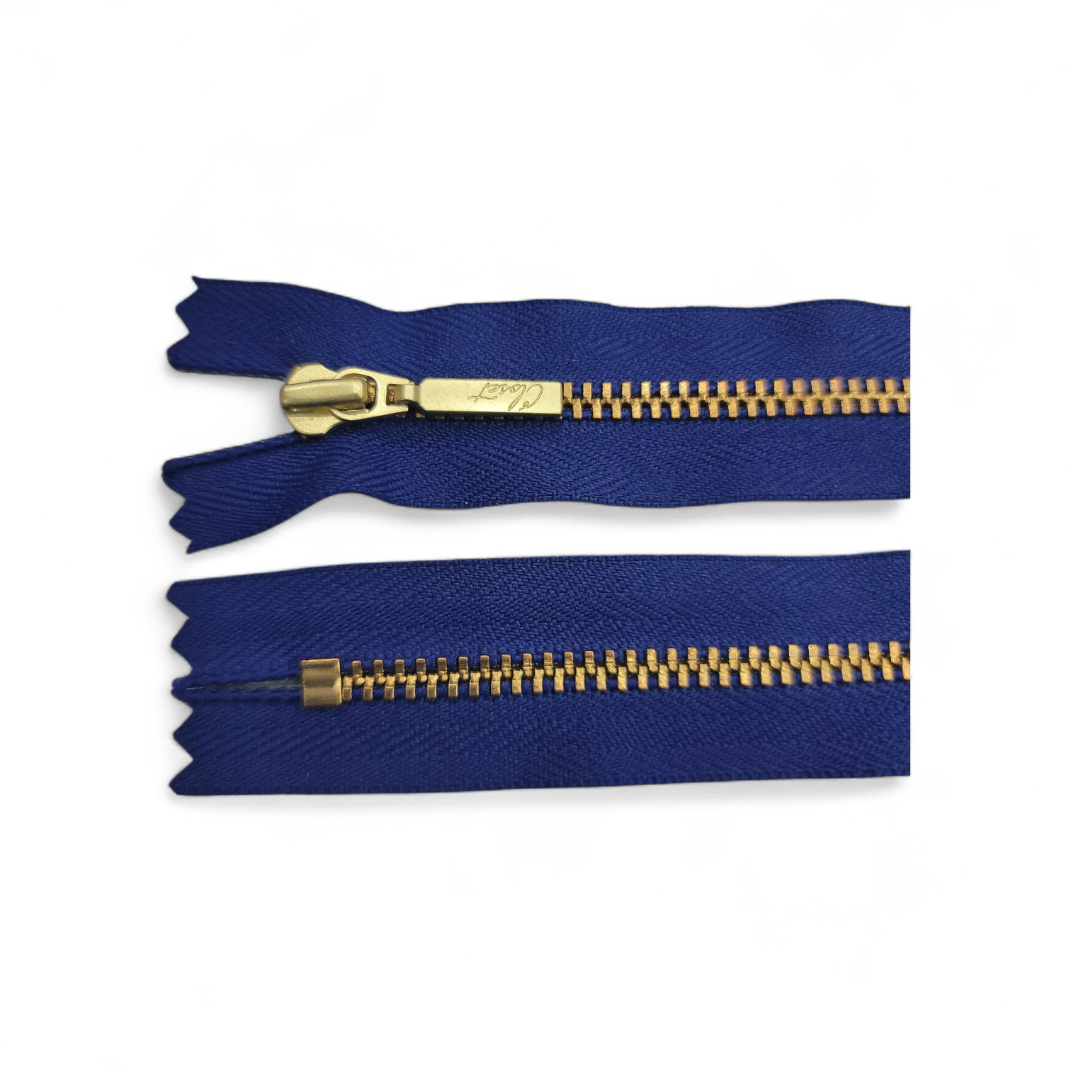 YKK Size 3 closed end gold metal zipper with blue fabric.