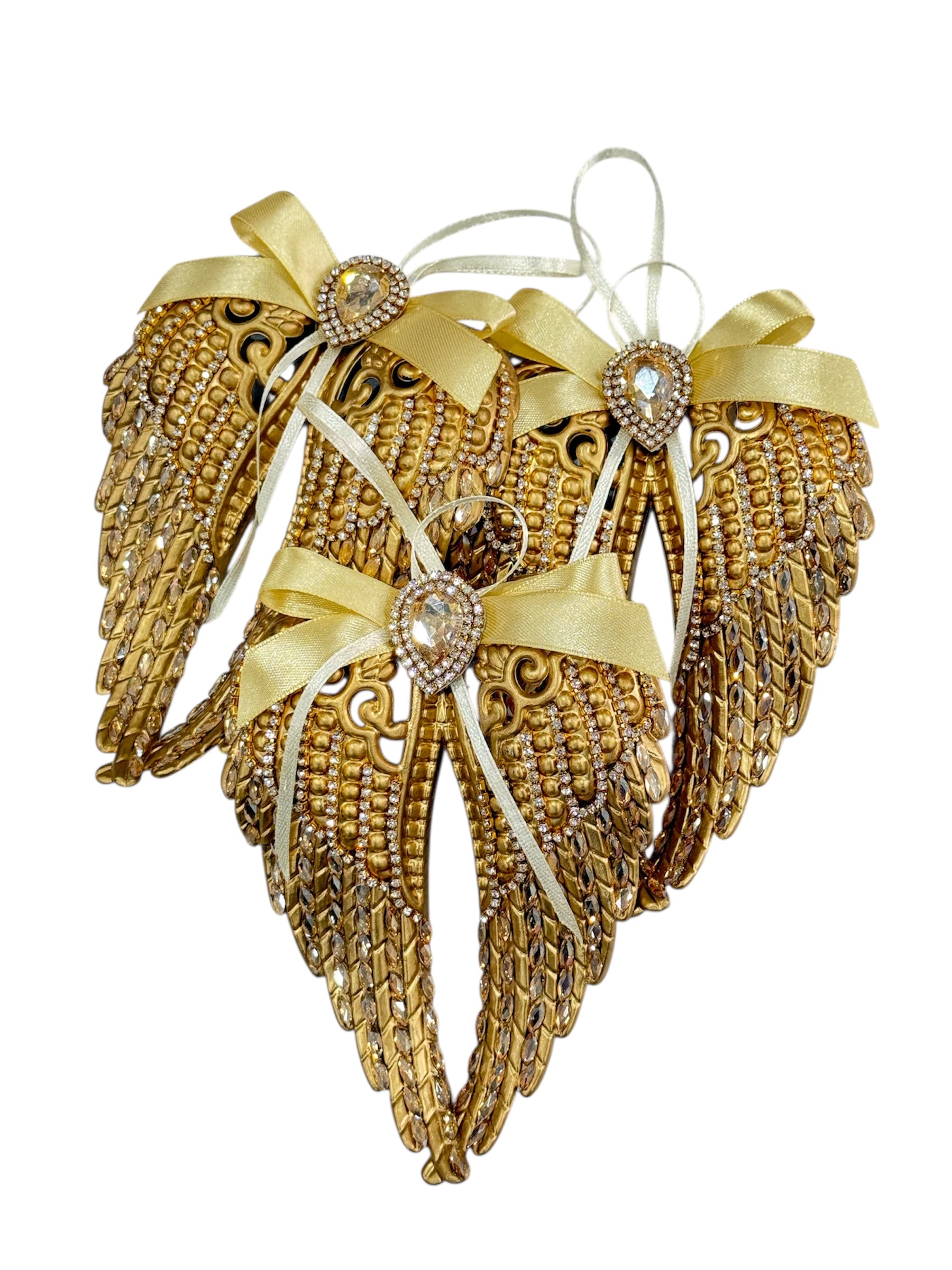 Golden Christmas decorative ornaments with rhinestones and ribbons.