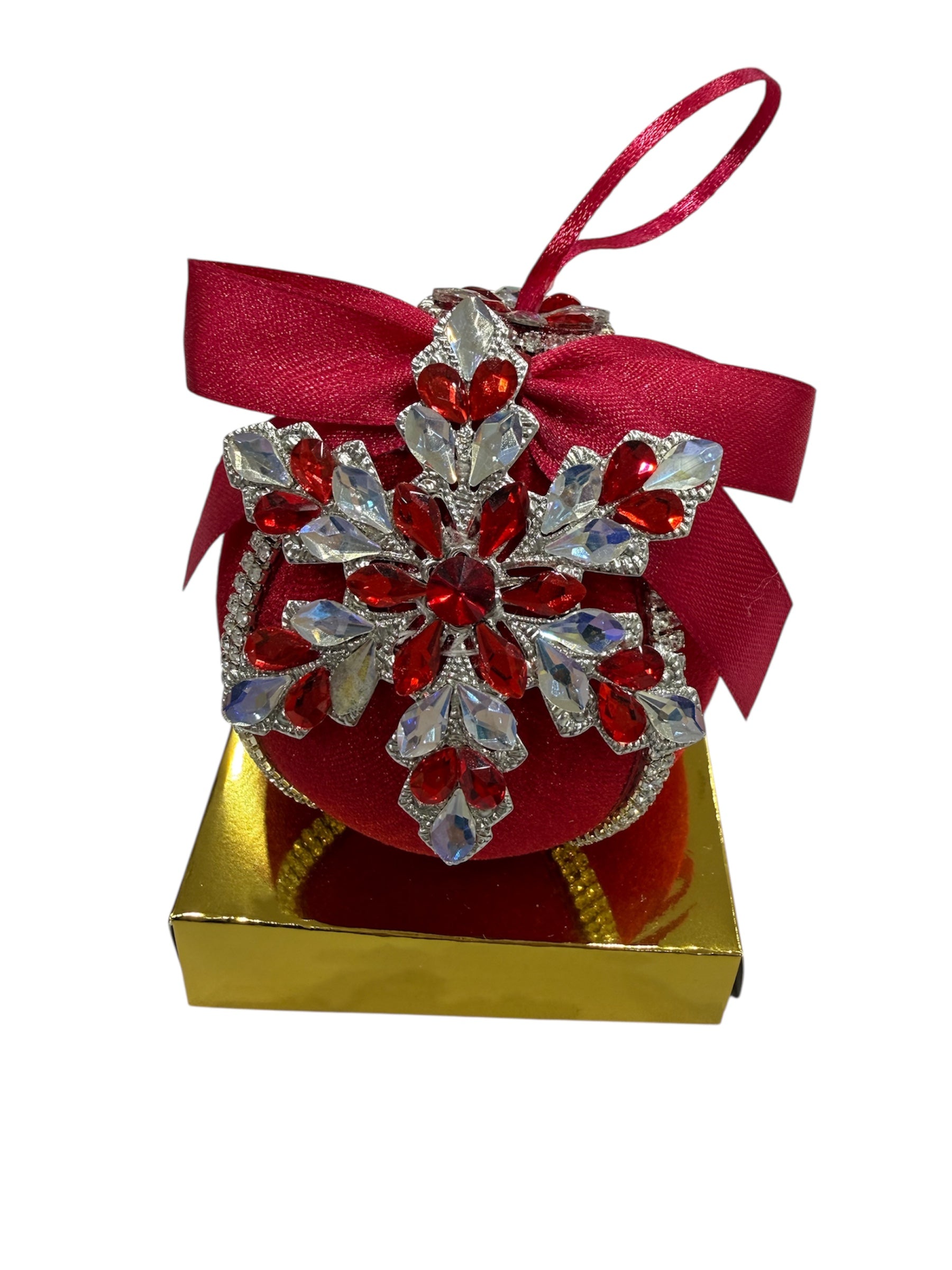 Red round Christmas ornament with snowflake embellishment and red ribbon.