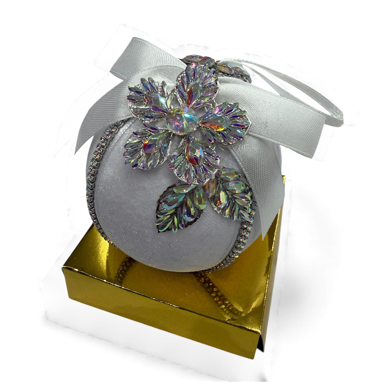 Round Christmas ornament with iridescent crystal flower and silver ribbon.