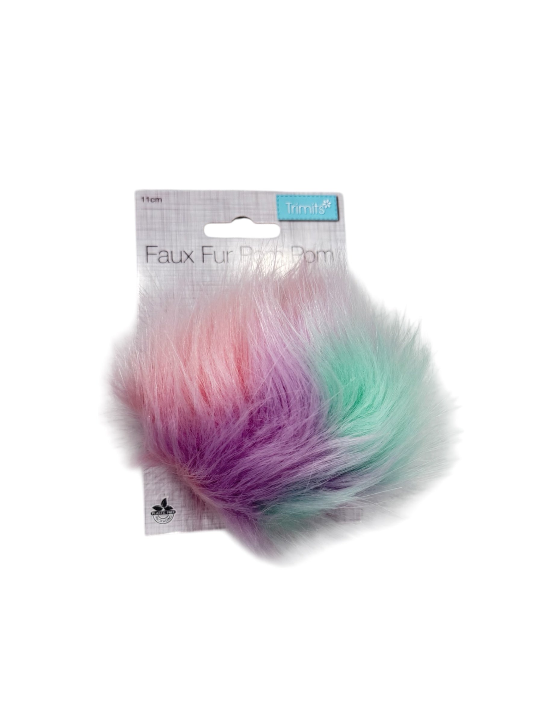 A pastel ombre faux fur pompom with a "Trimits" logo and "Plastic Free Packaging" label.