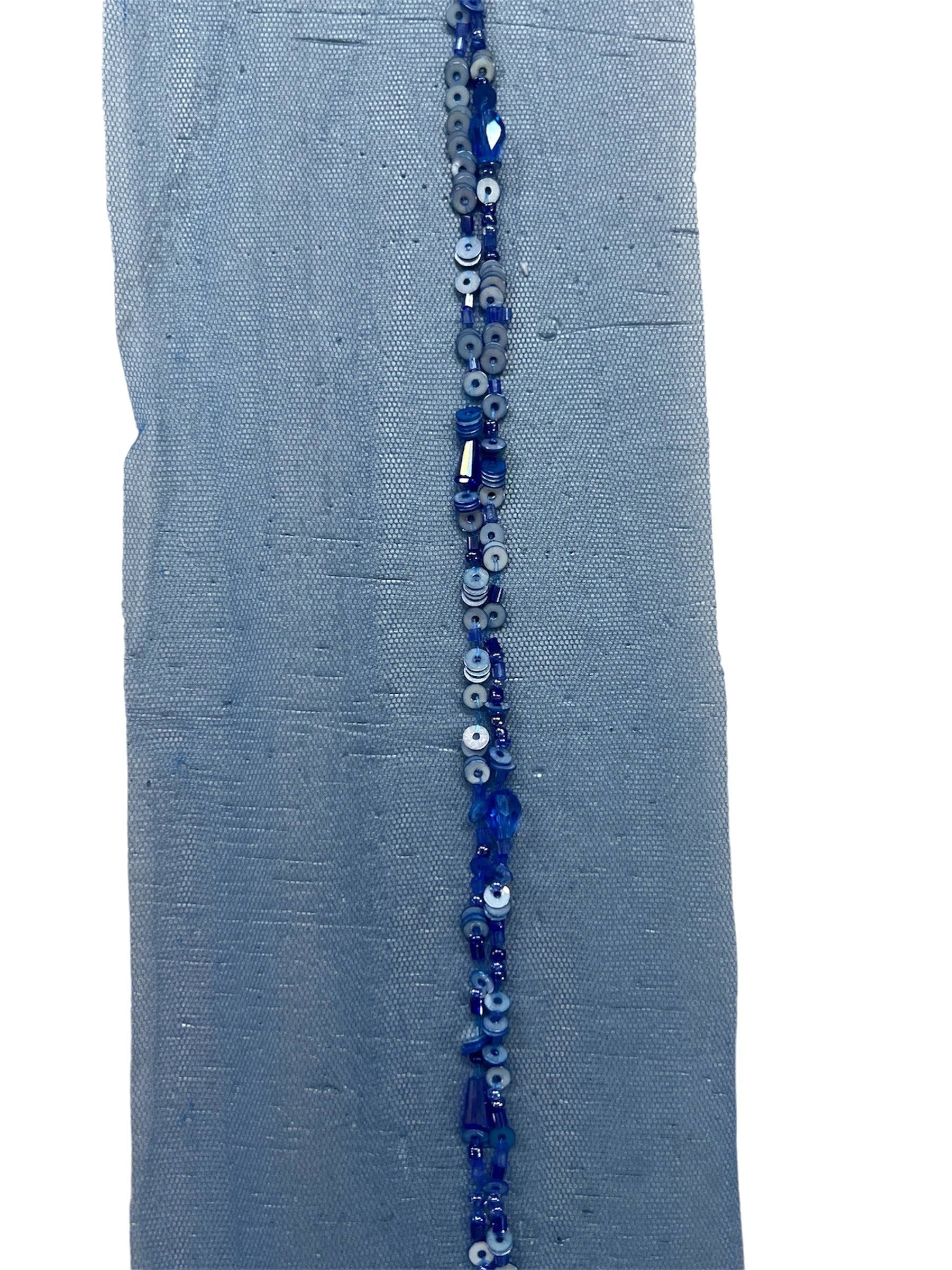 Blue hand-beaded sequin tape with intricate beadwork on a mesh backing.