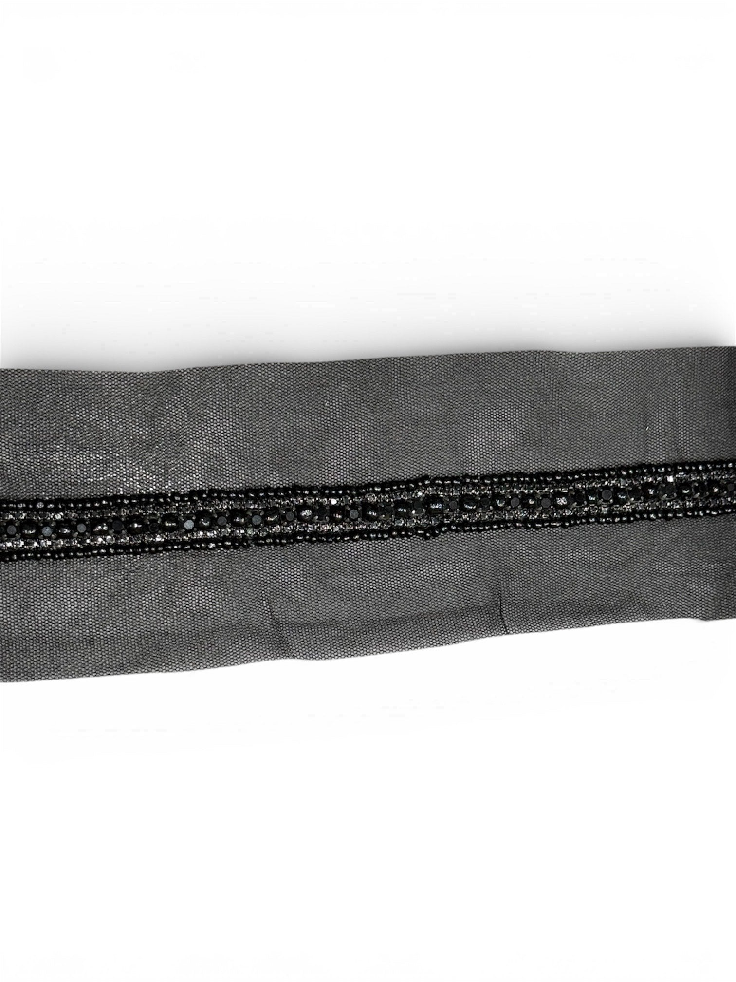 Black embroidered fabric trim with beads on a mesh background.